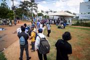 Venezuelanos e outros estrangeiros aguardam na fila