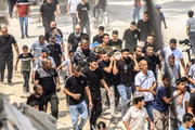 Pessoas carregam os corpos de vários palestinos, entre os cinco mortos em um ataque aéreo israelense no campo de refugiados de Nour Shams