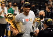 MILWAUKEE, WISCONSIN - JULY 20: Giannis Antetokounmpo #34 of the Milwaukee Bucks holds the Bill Russell NBA Finals MVP Award and the Larry O'Brien Championship Trophy after defeating the Phoenix Suns in Game Six to win the 2021 NBA Finals at Fiserv Forum on July 20, 2021 in Milwaukee, Wisconsin. NOTE TO USER: User expressly acknowledges and agrees that, by downloading and or using this photograph, User is consenting to the terms and conditions of the Getty Images License Agreement. (Photo by Justin Casterline/Getty Images)