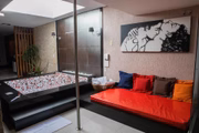 Barra de <i>pole dance</i> e vários <i>futons</i> completam o ambiente