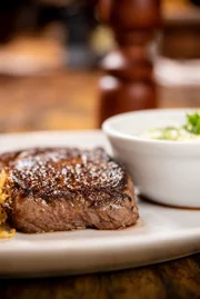 A seção de carnes do menu apresenta t-bone, prime rib, ribeye, costela, filé mignon, cotoleta, NY Strip (contrafilé com gordura lateral) e rump steak (corte nobre de alcatra). Os valores vão de R$ 89 e R$ 279