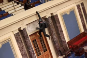 Manifestante escalando o Capitólio
