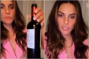 Dayane Mello segurando garrafa de vinho