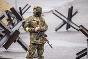 Soldados ucranianos patrulham em frente ao Monumento da Independência durante ataques russos em Kiev