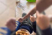 Felipe aponta para letras no braço do pai 